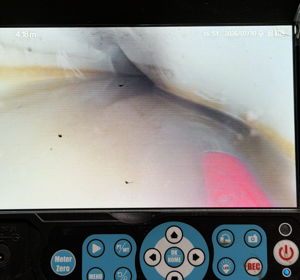 Drain camera monitor showing the inside of a pipe 4.18 metres in