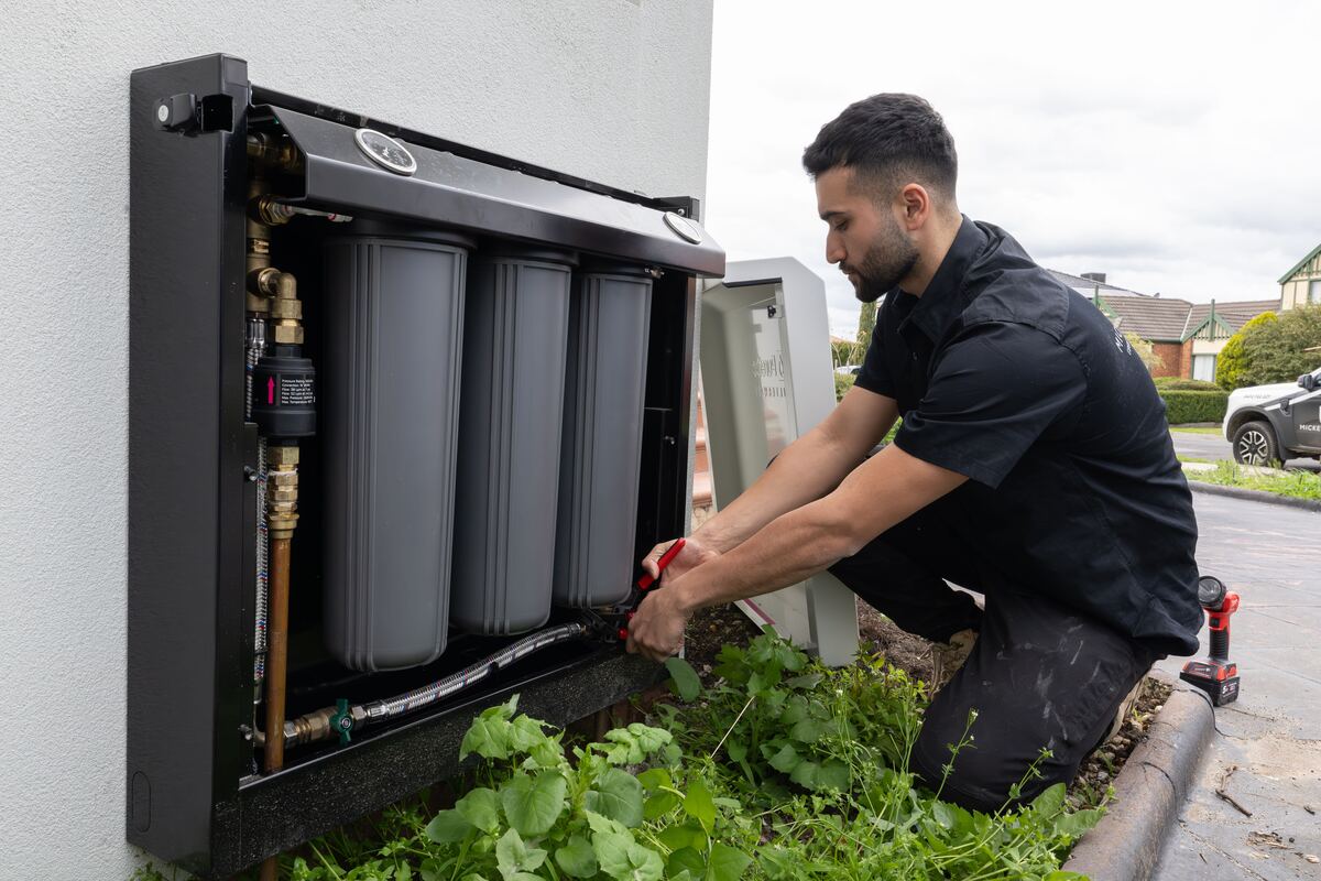 Murat from Mickey Plumbing servicing a whole-house water filtration system